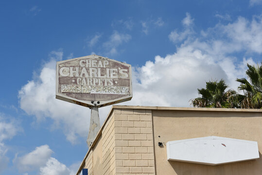 BUENA PARK, CALIFORNIA - 20 SEPT 2023: The faded sign atop Cheap Charlies Carpet on Lincoln Avenue.