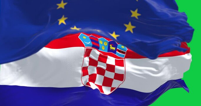 The flags of Croatia and the European Union waving isolated on green background