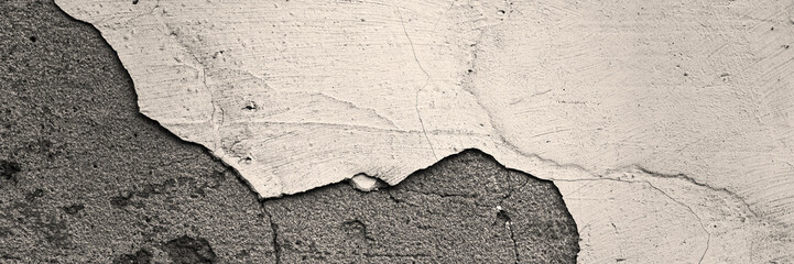 Old wall with cracked stucco. Weathered rough surface. Wide panoramic texture for background and design.