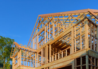 Work in progress view of unfinished house construction with wooden framing beams