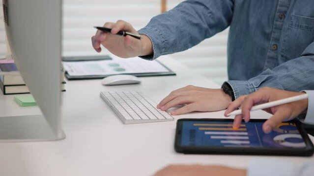 Closeup people hand two analyst man team talking work on tablet laptop SEO plan ideas report at office desk. Reskill upskill job training program course advice coding data mining digital skill project
