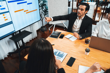 Project manager planning schedules for business task at meeting room, Gantt chart software show on...