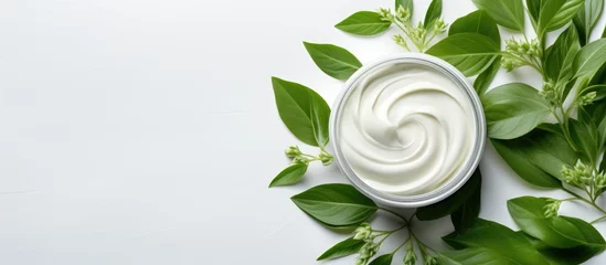 Rolgordijnen Organic skincare cream with plants on white background top view Dermatology concept with green leaves banner © TheWaterMeloonProjec