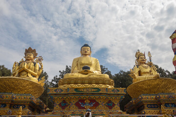 Fototapeta na wymiar The Golden Buddha Statues in Buddha park, Swayambhunath area, Kathmandu, Nepal, the World Heritage Site declared by UNESCO