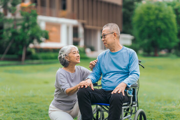 Asian people mature husband and wife, one in wheelchair, savoring peaceful outdoor moments in garden. Love and togetherness in midst of nature beauty. long live togetherness, valentine, insurance