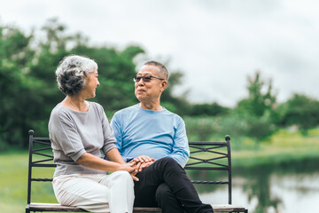 Asian people mature husband and wife, seated on chairs, elderly couple, seated in the park on comfortable chair, deep love and lifelong. Elderly Love Senior Couples, long life togetherness