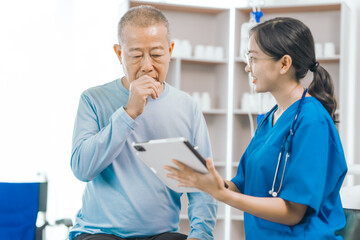 Elderly man engages in thoughtful discussion with compassionate asian people female doctor,...