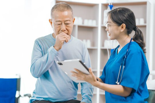 Elderly man engages in thoughtful discussion with compassionate asian people female doctor, addressing health agenda and medical concerns, exemplifying importance of patient-centered care.