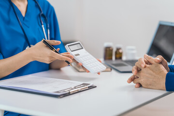 Cost of medical care, calculator, Asian people experienced female doctor giving advice to elderly...