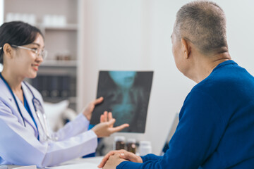 Fototapeta premium Asian people experienced female doctor giving advice to elderly male patient cancer and x-ray results and treatment options, Cancer Consultation, Elderly Man Receives Expert Cancer Advice Awareness