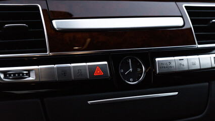 Red emergency button Interior of modern luxury car. Details of automatic transmission gear shift,...