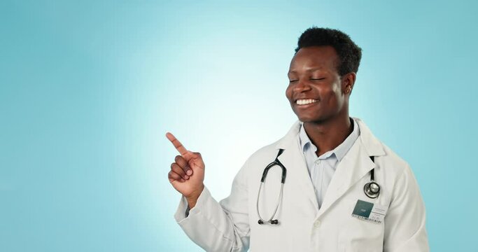 Black man, doctor pointing and studio for healthcare tips or information with presentation in mockup space on blue background. Portrait, medical news or announcement with health advertising or launch