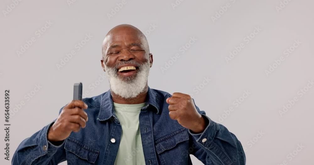 Poster Fist, win and man celebrate phone call, dance and connection on a grey studio background. African person, senior model or winner with cellphone, success and wow with prize, smile or giveaway