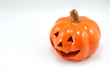 Halloween pumpkin toy plaster prop on abstract white gray background with copy space