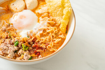 instant noodles with pork and meatballs in spicy soup