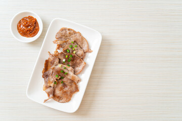 grilled pork neck sliced on plate