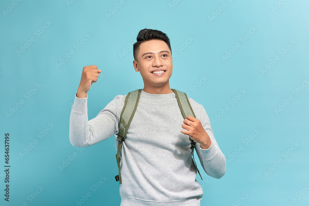 Wall mural attractive young man screaming and showing fists