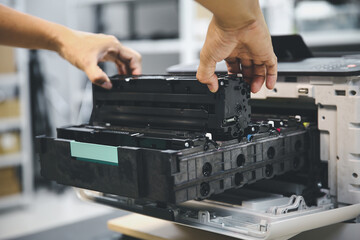 Technician hand open cover photocopier or photocopy to fix repair copier paper jam and replace ink...