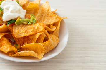 nachos tortilla chips with jalapeno, guacamole, tomatoes salsa and dip