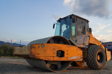 Fototapeta premium Eye catching yellow road roller with enclosed climate controlled 