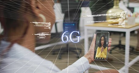 Animation of data processing over african american woman having a videocall on smartphone at office - Powered by Adobe
