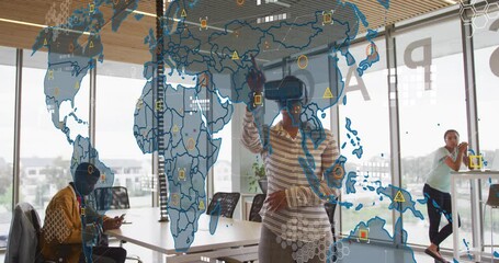 Animation of world map against african american woman wearing vr headset at office - Powered by Adobe