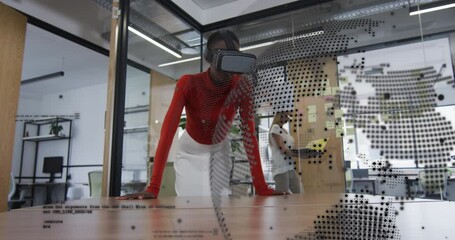 Animation of spinning globe, data processing on african american woman wearing vr headset at office - Powered by Adobe