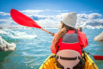 kayaking in Iceland next to an iceberg - obrazy, fototapety, plakaty