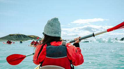 kayaking in Iceland next to an iceberg