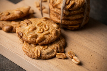 Round cookies with roasted peanuts on a wooden cutting board.
Delicious cookie image.
