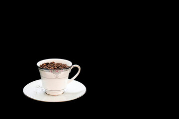 Closeup of a cup of coffee grains on black background with copy space.