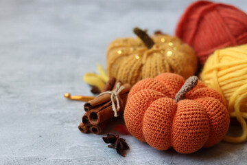 Cozy autumn crochet. Close  up photo of handmade amigurumi toys made of natural yarn. Cute decorations for autumn holidays. Hobbies and leisure concept. 