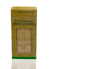 Disposable brown paper straws, Eco degradable paper straws pack isolated on white background with clipping path. Eco friendly and environmental concepts.