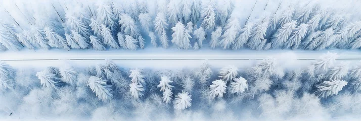 Fotobehang Aerial view of winter road in the forest. Winter landscape countryside. Aerial photography of snowy forest . Captured from above with a drone. Aerial photo. © Yulia