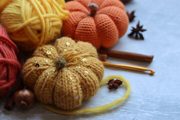 Cozy autumn crochet. Close  up photo of handmade amigurumi toys made of natural yarn. Cute decorations for autumn holidays. Hobbies and leisure concept. 