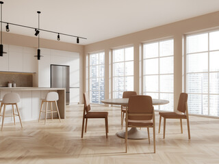 Beige kitchen corner with island and dining table