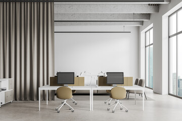 White office interior with pc computers and furniture, panoramic window