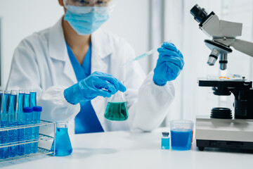 Modern medical research laboratory. female scientist working with micro pipettes analyzing...
