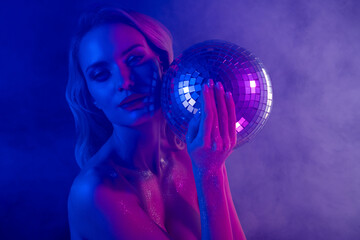 Portrait of sensual tempting woman dancing at vintage disco party shimmer on her body glowing over neon fog light