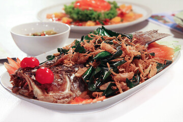 Fried Sea Bass with Herbs, Thai food, selective focused