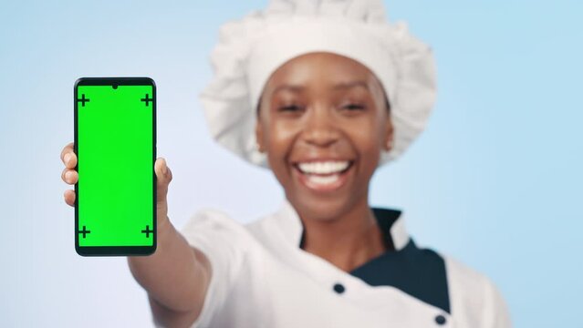 Chef, phone and woman with green screen or mockup with food blog, social media or show online recipe. Cooking, mobile app and portrait with restaurant menu promo and hand on blue background in studio