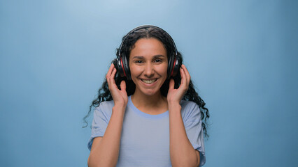Arabian woman happy Muslim girl carefree cheerful joyful lady female put on headphones dancing...