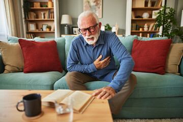 A senior man suffering from chest pain or heart attack at home