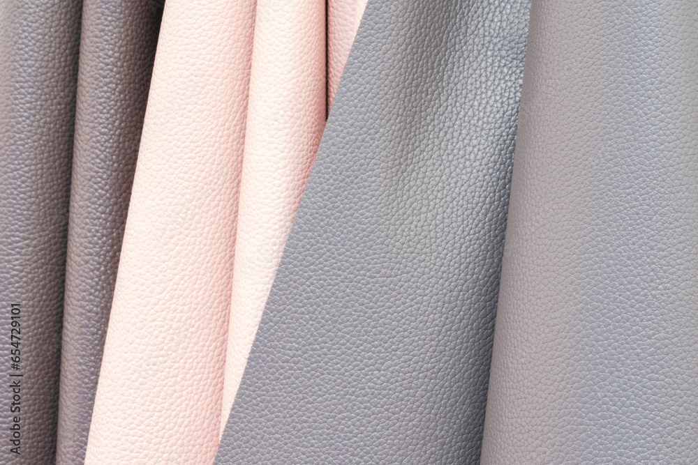 Poster mix colorful hanging vertical stripe leather on the rack. texture of multicolored leather close up.