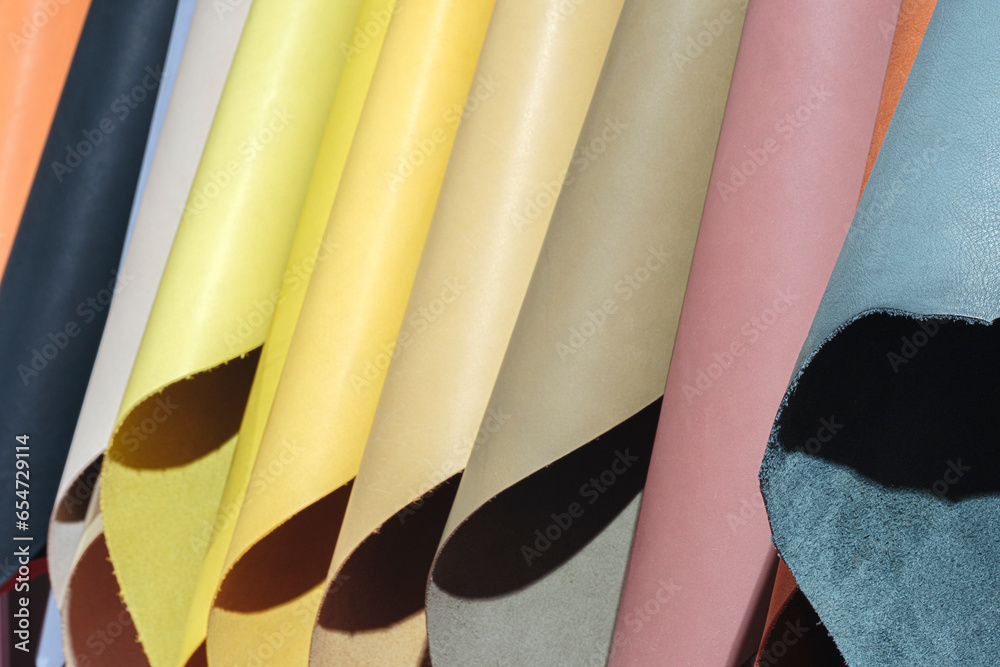 Aufkleber mix colorful hanging vertical stripe leather on the rack. texture of multicolored leather close up.