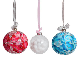New Year's Christmas balls of pink blue white color on a white background isolated. Balloons hang on a ribbon with a bow.
