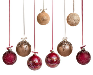 New Year's Christmas balls in brown burgundy gold color on a white background. Balloons hang on a ribbon with a bow.