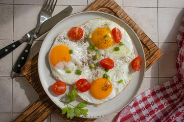 Fried eggs in a plate isolated on old background