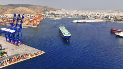 Aerial drone photo of Roll on Roll off automobile carrier ship cruising near terminal port of...