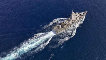 Aerial drone photo of armed navy frigate cruising deep blue sea - obrazy, fototapety, plakaty